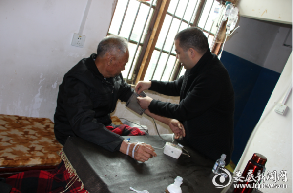 （院长邹奇为贫困老人测量血压）