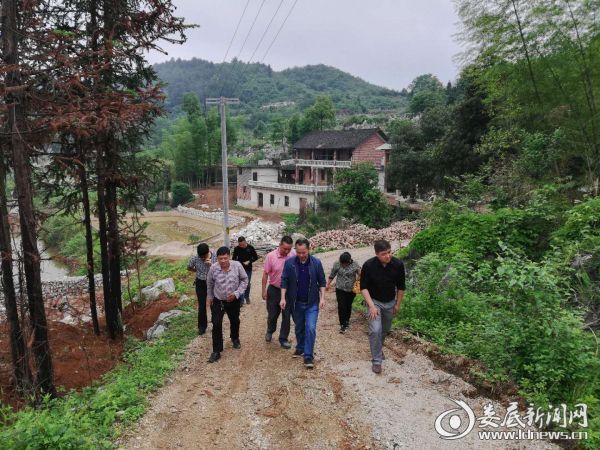 图为县民政局领导在村内调研指导扶贫工作