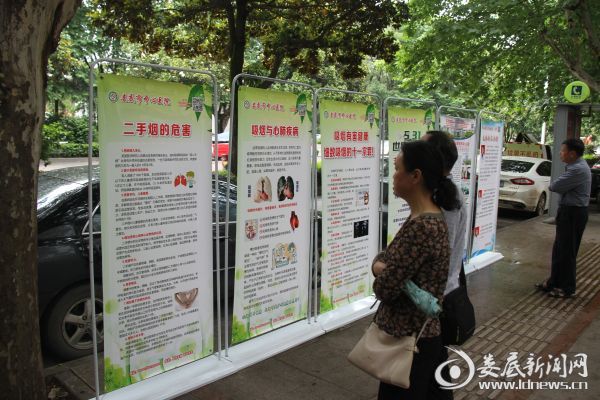 过路群众观看宣传展板