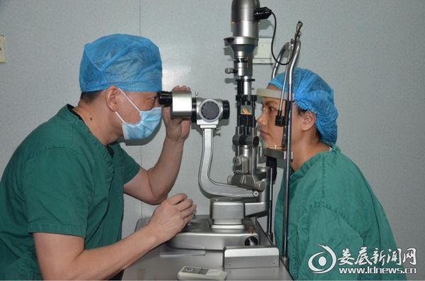 娄底爱尔眼科医院副院长兼屈光中心主任周映旗为当天实施全飞秒手术的患者做术后检查