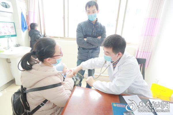 儿科副主任医师罗付华为患儿听诊）