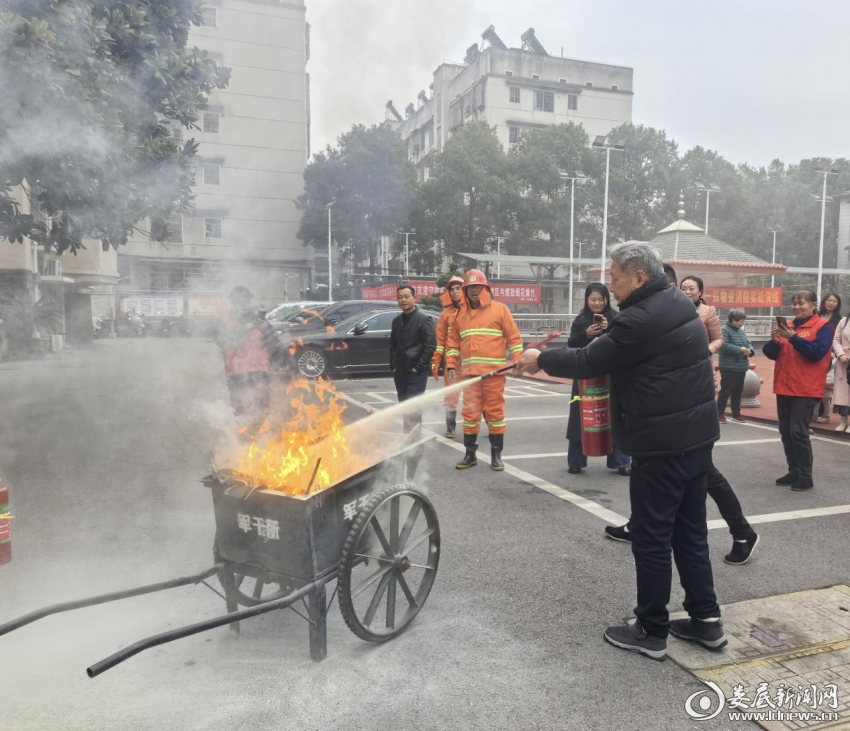 （军休干部手持灭火器灭火）